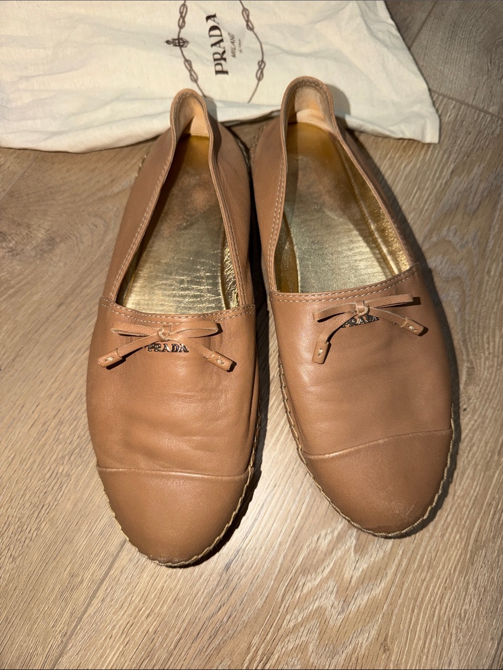 Prada Calzature Donna Nappa leather slip-on espadrilles in a tan color